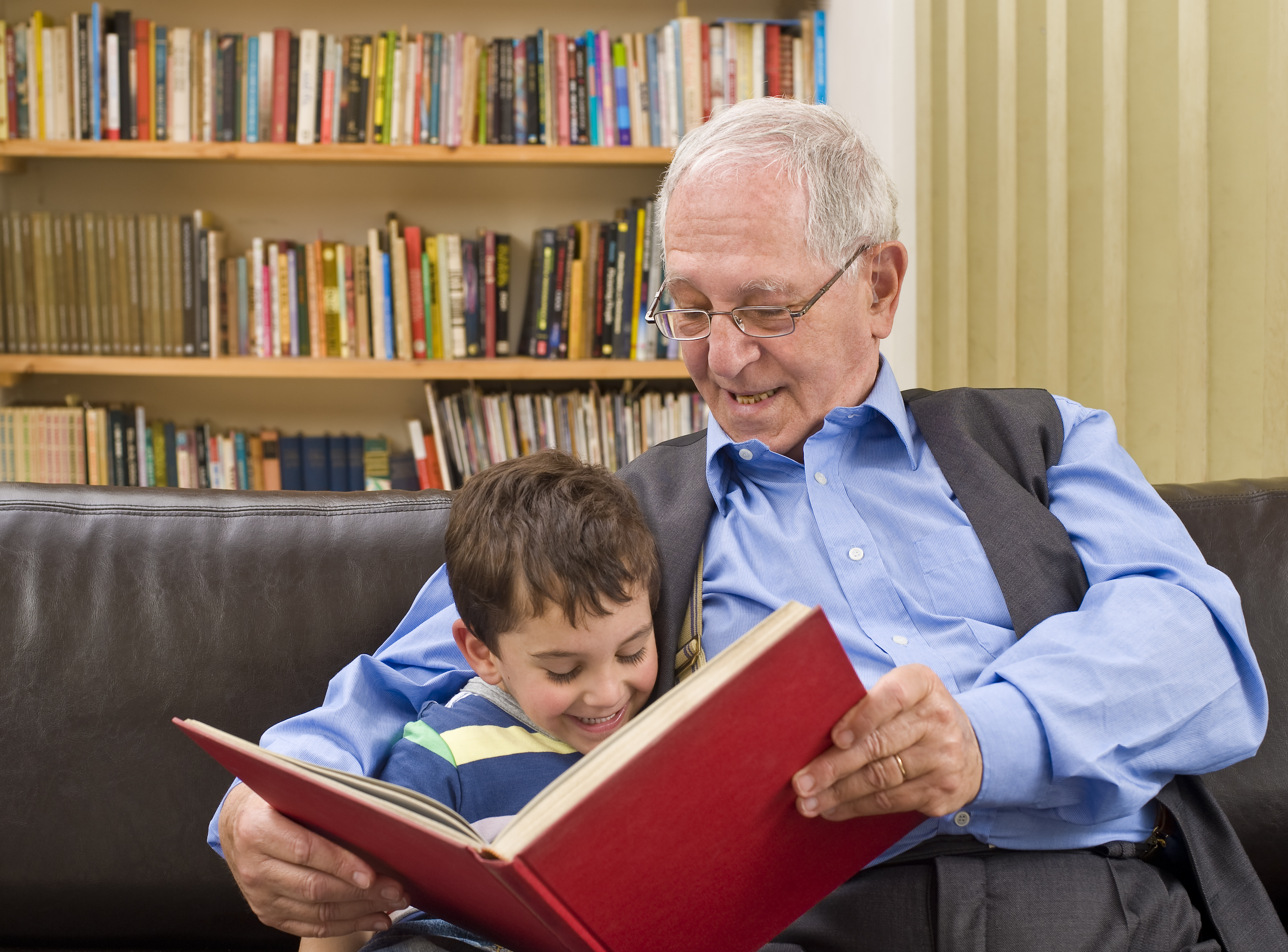 grandfather reading a story to his grandchild